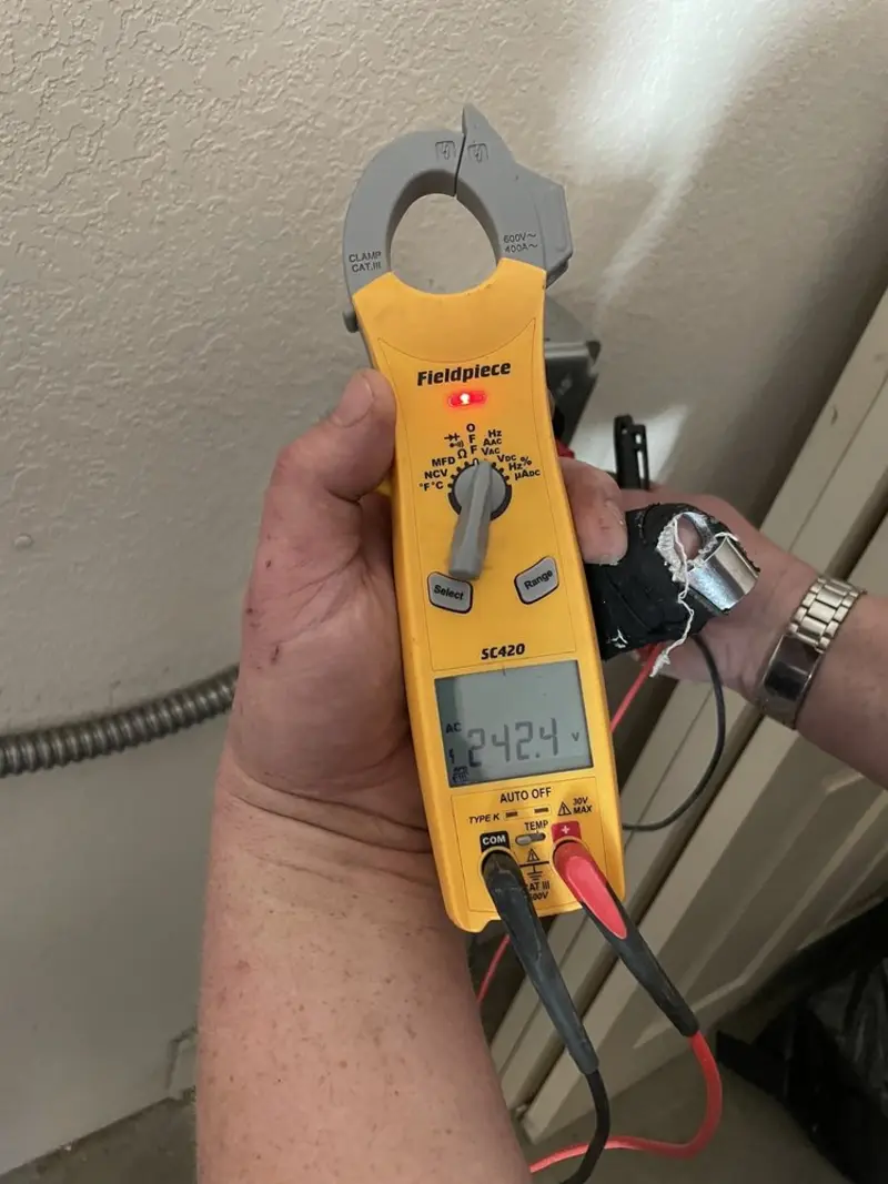 Voltage testing with clamp meter during Recessed Lighting Installation in Rantoul